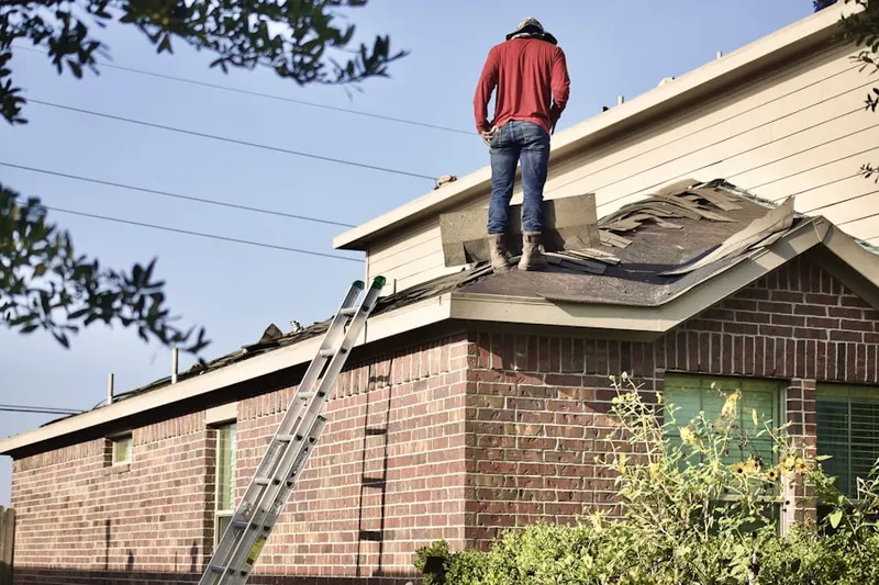 Professional roofer working on a residential roof in Marley Village